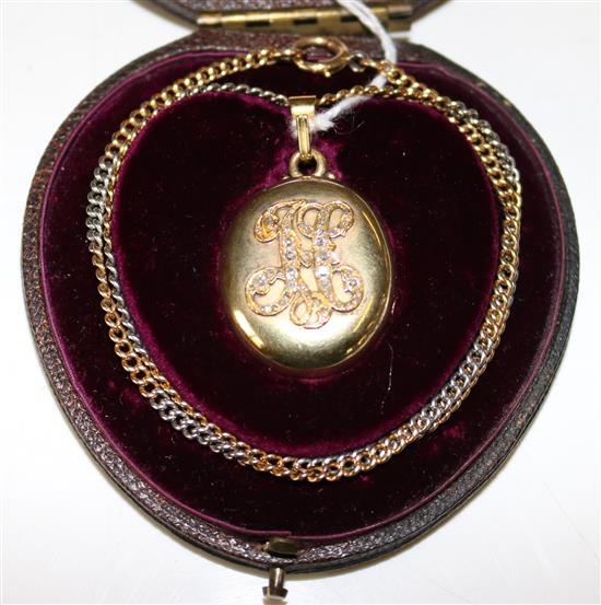 A Russian 14K gold oval locket with diamond set initial H, on a two-colour gold curb-link chain,